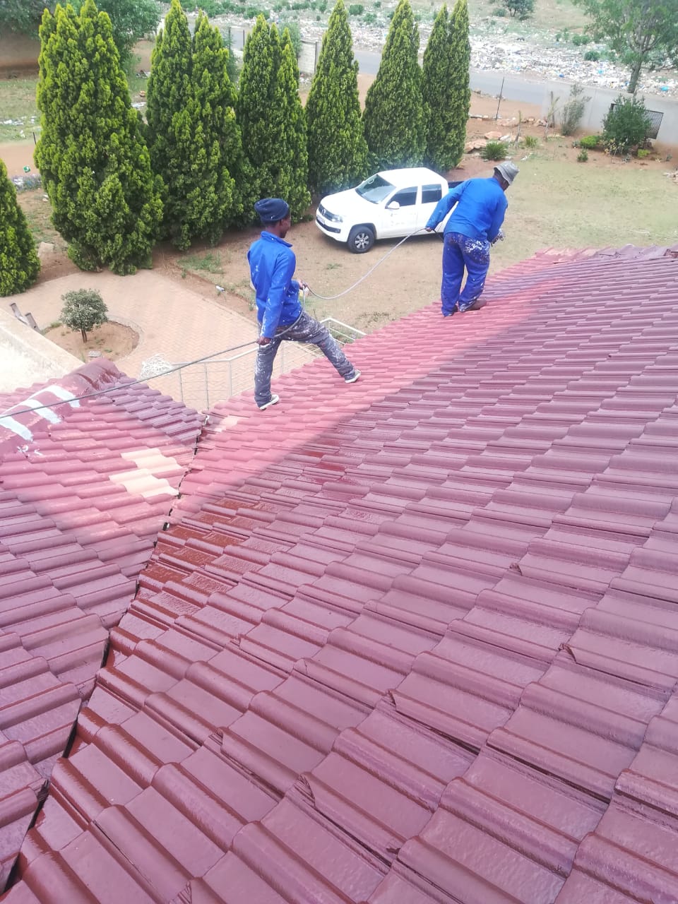 Roofers on tile roof